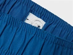 Justerbar elastik med knaphuller i taljen på blålige badeshorts med paw patrol print fra Name It 13239656 parisian blue